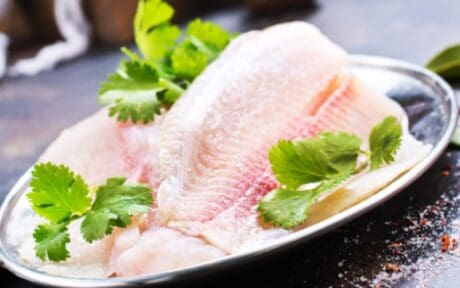 a plate of fish with parsley