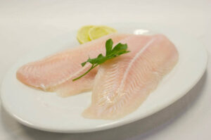 a plate of fish on a white surface