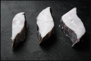 a group of fish on a black surface