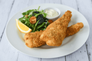a plate of fried fish and salad