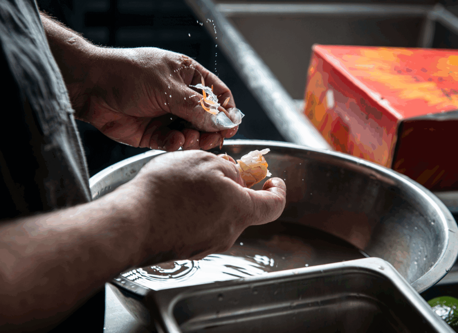 a person washing a piece of food
