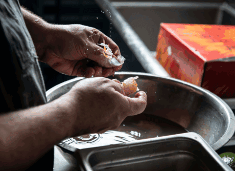 a person washing a piece of food