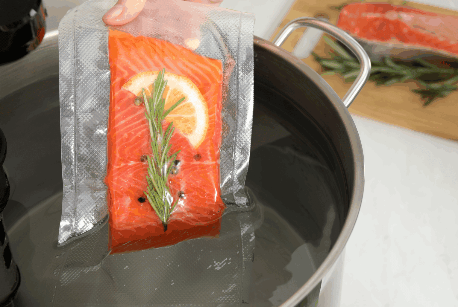 a piece of salmon with rosemary in a pot of water