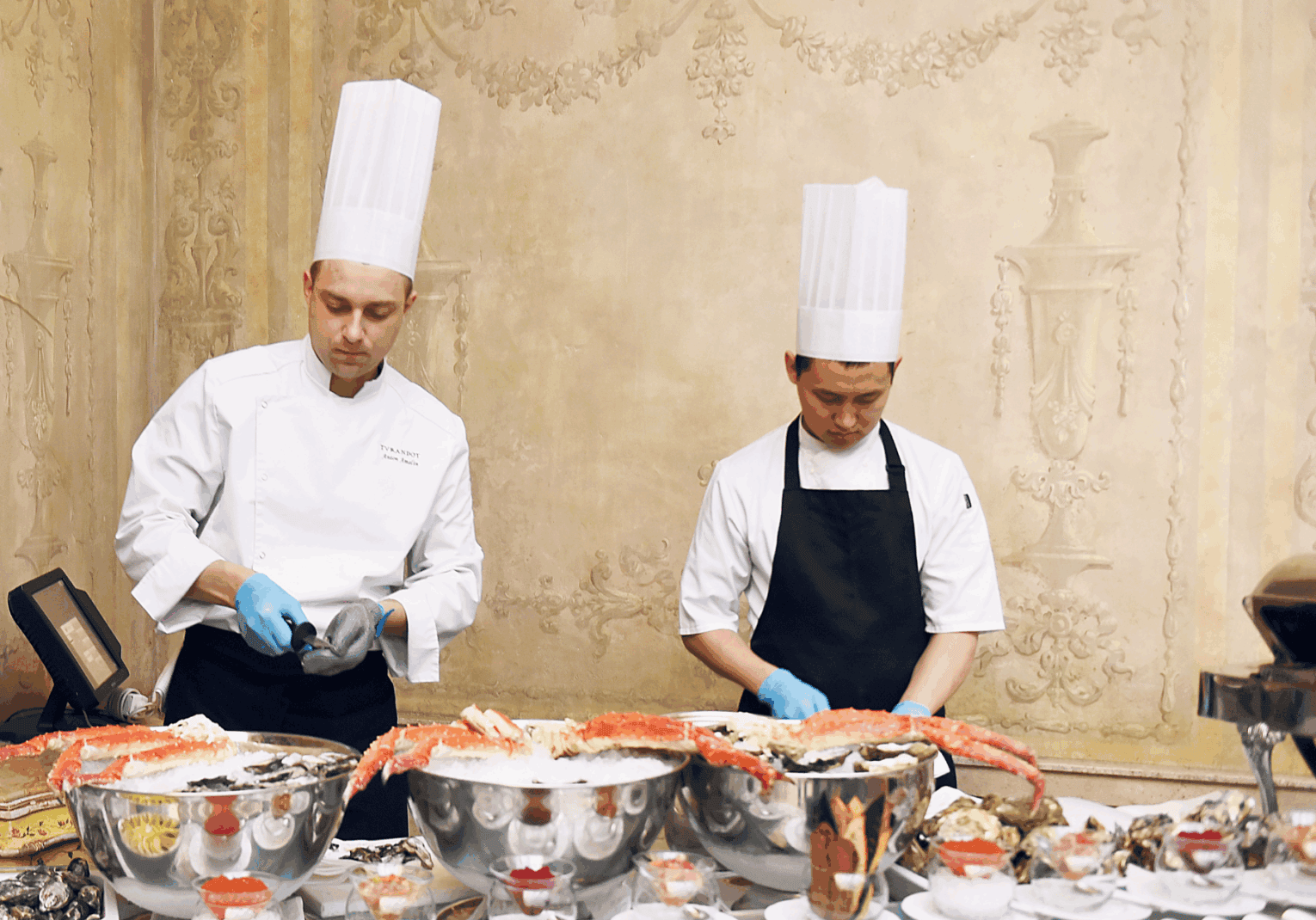 two chefs preparing food in a restaurant