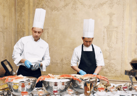 two chefs preparing food in a restaurant
