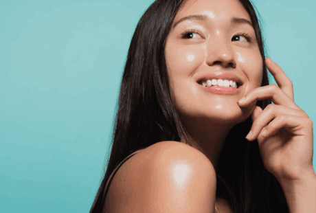 a woman smiling with her hand on her chin