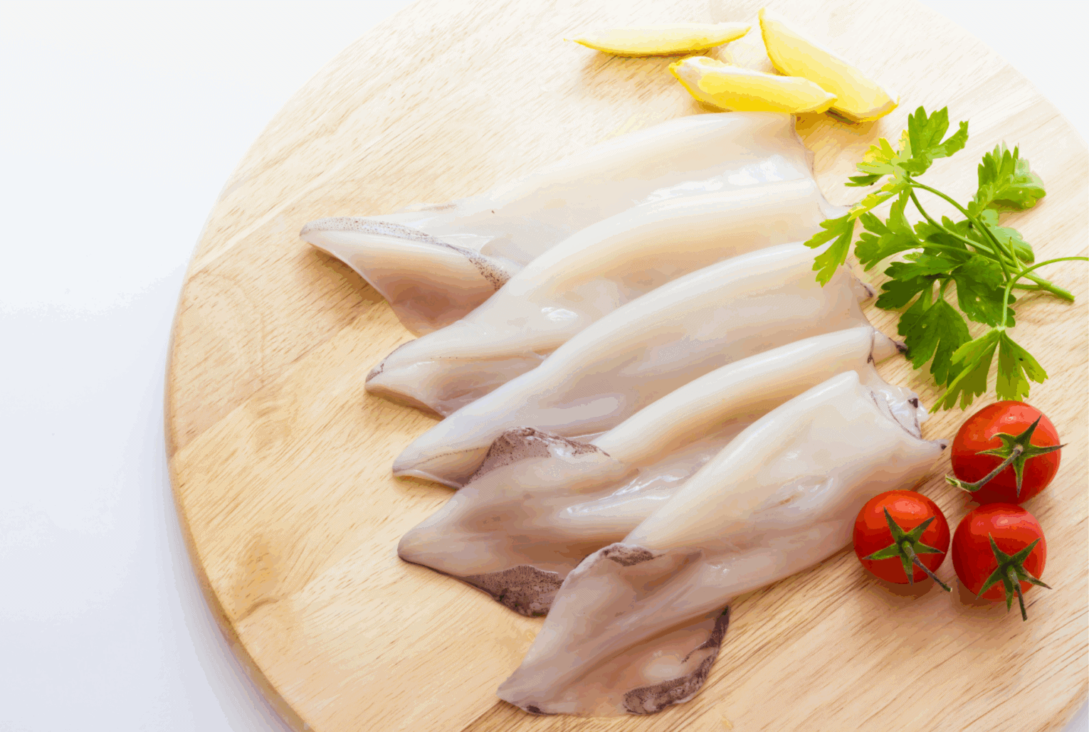 a group of raw fish on a wooden board