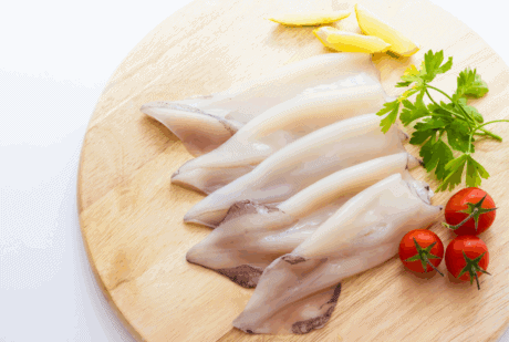 a group of raw fish on a wooden board